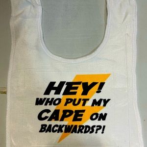 My capes on backwards baby bib